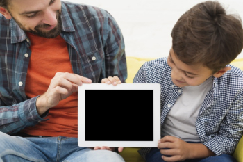 Father and son holding a mock up photo Free Photo