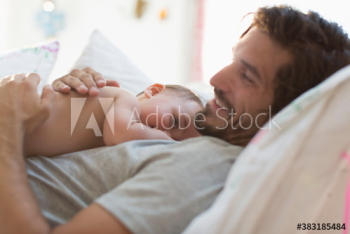 Father cuddling baby son Father cuddling baby son