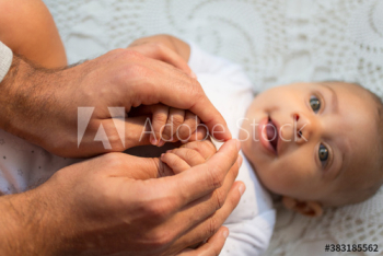 Father holding hands of baby son Father holding hands of baby son