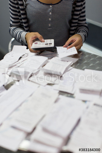 Female accountant calculating receipts in office Female accountant calculating receipts in office