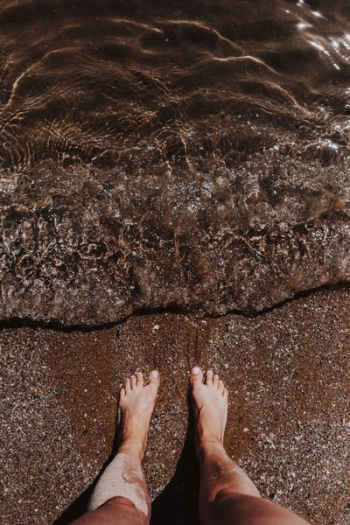 Female legs in the sand