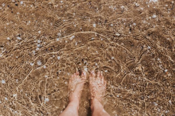 Female legs in the sand