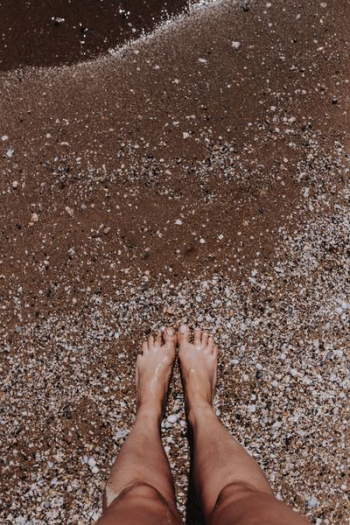 Female legs in the sand