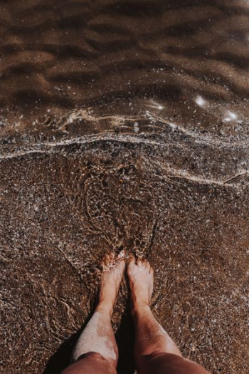 Female legs in the sand