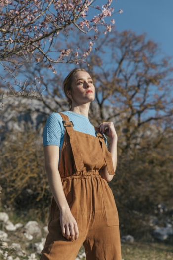 Female model posing under blooming tree Free Photo