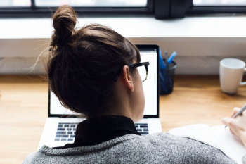 Female Taking Notes And Browsing Laptop Female Taking Notes And Browsing Laptop