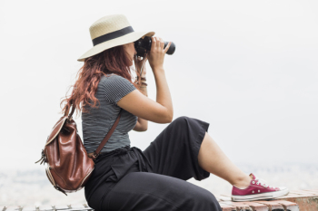 Female tourist with binoculars Female tourist with binoculars