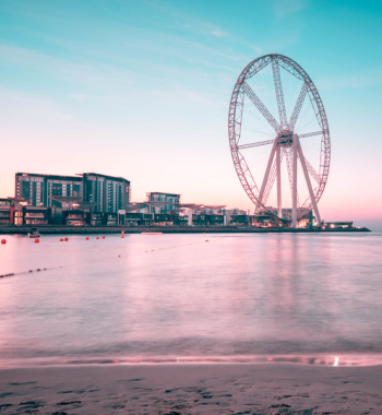Ferris Wheel Near Body of Water and High Rise Building