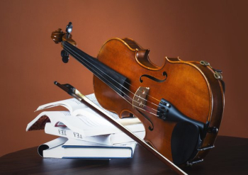 Fiddle And Bow Rest On Stack Of Books Fiddle And Bow Rest On Stack Of Books