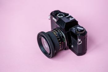 Film Camera On Pink Background Film Camera On Pink Background