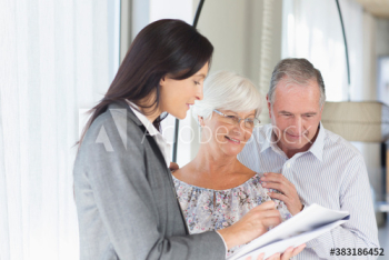 Financial advisor discussing paperwork with senior couple Financial advisor discussing paperwork with senior couple
