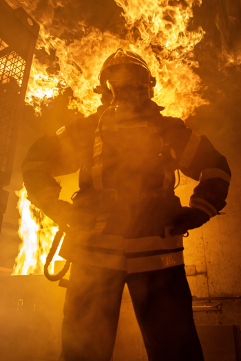 Fireman Standing Near Fire on Building