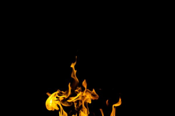 flame against black background flame against black background