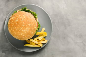Flat-lay burger and fries on plate with copyspace Free Photo Flat-lay burger and fries on plate with copyspace Free Photo