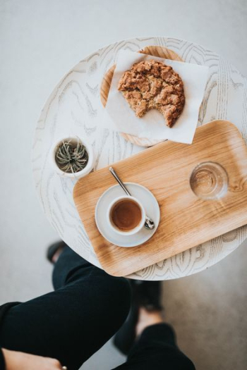 flat-lay photography of pastry and liquid-filled cup on tray flat-lay photography of pastry and liquid-filled cup on tray