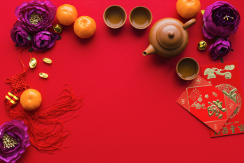 Flowers and tangerines near tea ceremony supplies