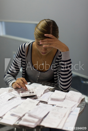 Focused female accountant calculating receipts in office Focused female accountant calculating receipts in office