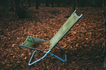 folding lounger on dried leaves folding lounger on dried leaves