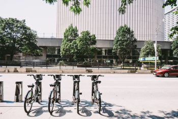 Four Black Parked Bicycles Near the Road Four Black Parked Bicycles Near the Road