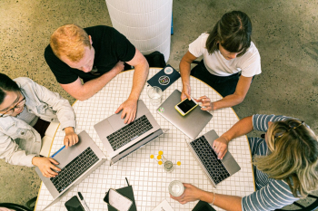 Four People Using Laptop Computers and Smartphone Four People Using Laptop Computers and Smartphone