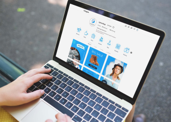 Free Laptop with Hand Mockup - Graphicfolks