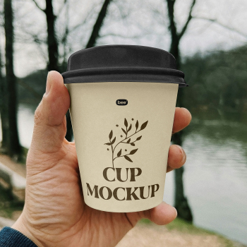 Free Small Paper Cup in Hand Mockup