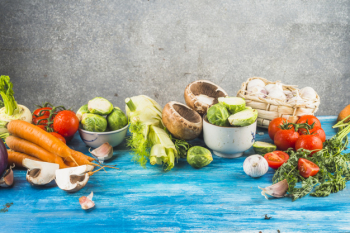 Fresh organic vegetables on blue organic tabletop Fresh organic vegetables on blue organic tabletop