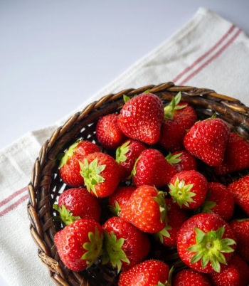 Freshly Harvested Strawberries in Woven Basket Freshly Harvested Strawberries in Woven Basket