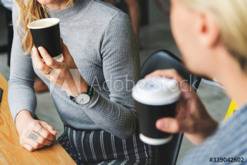 Friends enjoying a hot coffee together Friends enjoying a hot coffee together