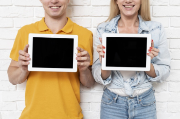 Front view friends holding tablets mock-up Free Photo