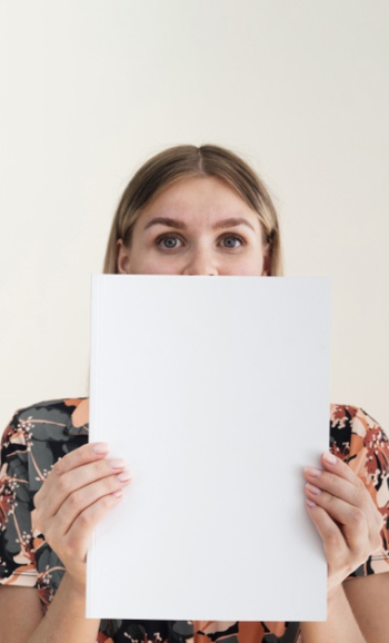 Front view woman holding a mock-up magazine Free Photo