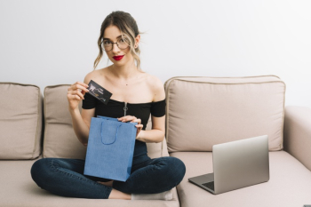 Front view woman opening shopping bag Free Photo