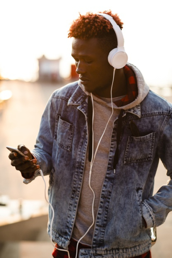 Front view young man checking music playlist Free Photo