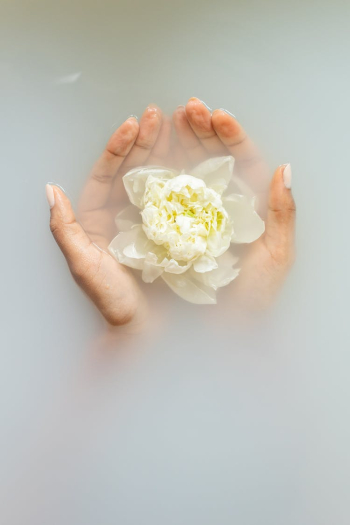 Gentle woman with flower in hands