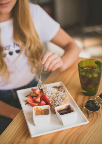 girl eating strawberry waffle girl eating strawberry waffle