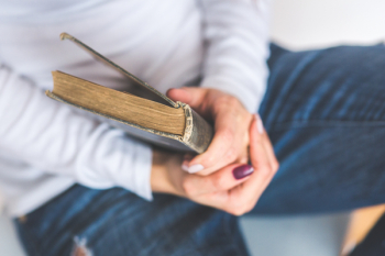 Girl holding an old closed book Girl holding an old closed book