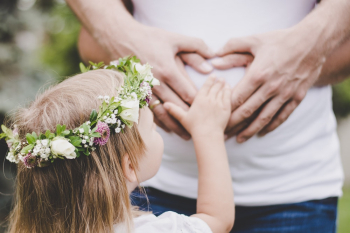 Girl Holding Her Mother&#39;s Tummy