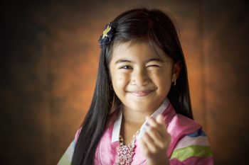 Girl Smiling Doing Finger Heart Sign Girl Smiling Doing Finger Heart Sign