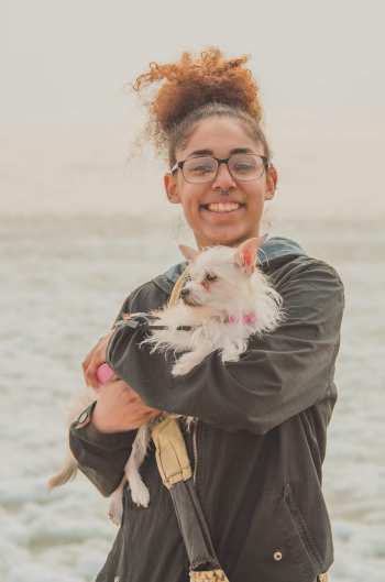Girl Smiling While Carrying Her Dog Girl Smiling While Carrying Her Dog