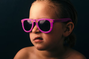 girl wearing pink framed sunglasses