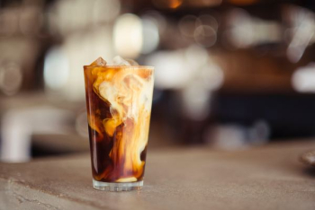 glass cup filled with ice latte on tabletop glass cup filled with ice latte on tabletop