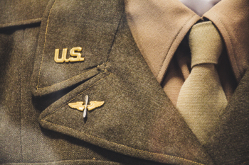 Gold-colored Us Brooch on Apparel Gold-colored Us Brooch on Apparel