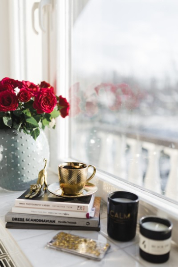 Gold cup of coffee and red roses bouqet Gold cup of coffee and red roses bouqet
