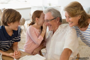 Granddaughter sharing secret with grandfather Granddaughter sharing secret with grandfather
