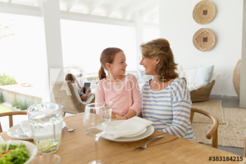 Grandmother and granddaughter talking at lunch table Grandmother and granddaughter talking at lunch table