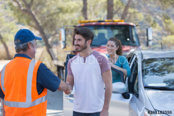 Grateful man shaking hands with roadside assistance mechanic Grateful man shaking hands with roadside assistance mechanic