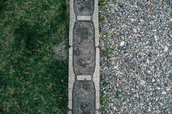 Gravel and Grass Separated by Concrete Surface Gravel and Grass Separated by Concrete Surface