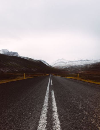 gray asphalt road under cloudy sky gray asphalt road under cloudy sky