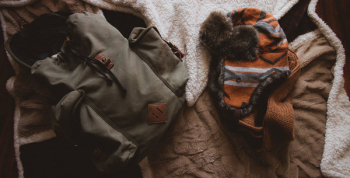 Gray Backpack Beside Orange Knit Hat Gray Backpack Beside Orange Knit Hat