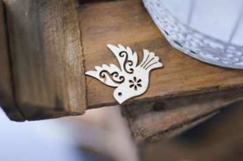 gray bird cutout decor on brown plank gray bird cutout decor on brown plank